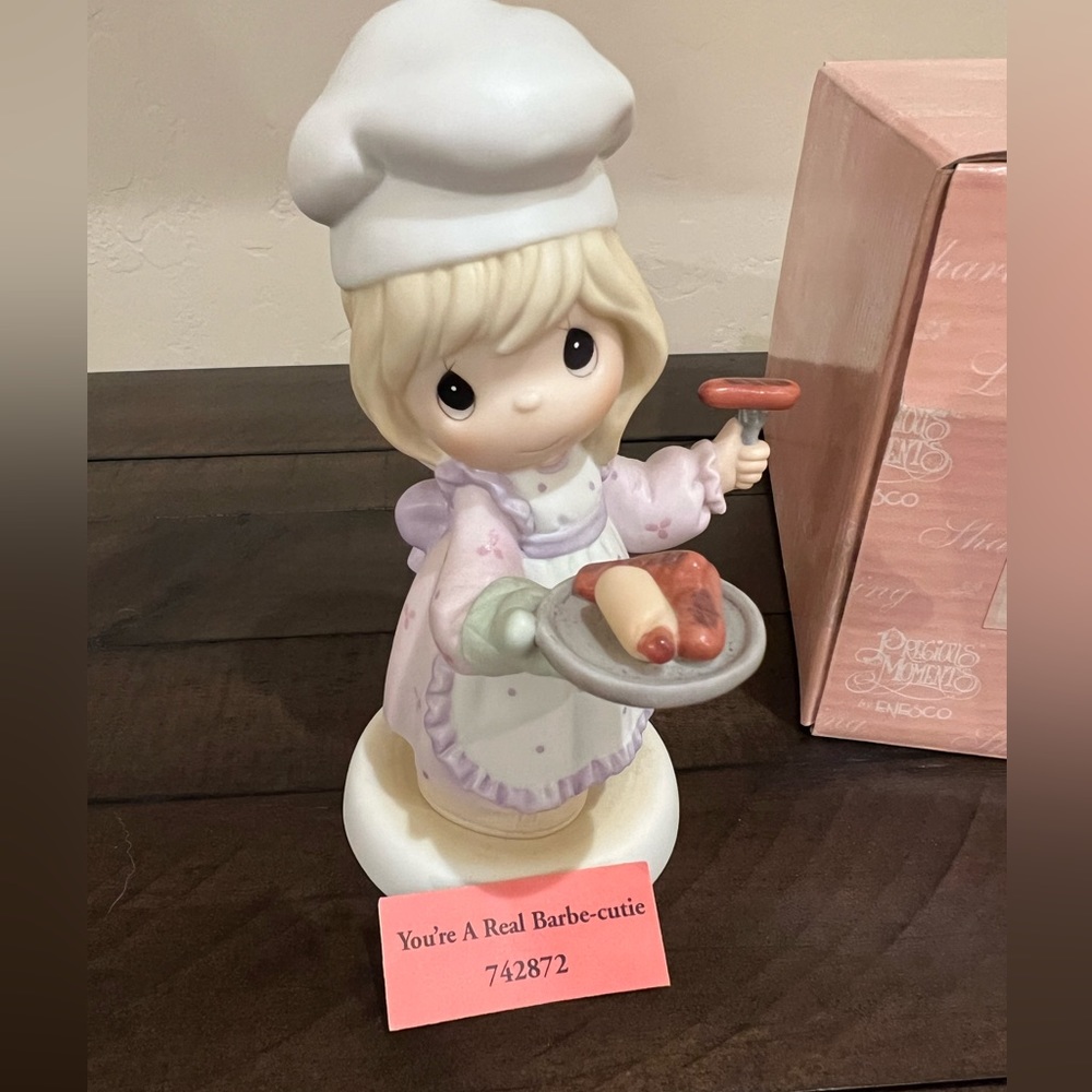 Precious moment, you’re a real barbe-cutie. Female porcelain figurine barbecuing